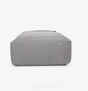 Detailed bottom view of the grey fabric laptop backpack showing reinforced stitching