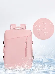 Detail of pink waterproof travel backpack fabric showing water-resistant coating and droplets