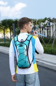 Blue cycling hydration pack with reflective straps and water tube shown in outdoor use