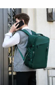 Detail view of dark green travel backpack with external USB charging port and buckles