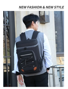 Black insulated picnic backpack with gray zipper and elastic cords shown on male model