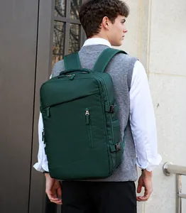 Detail of a dark green waterproof travel backpack with large capacity and side buckles