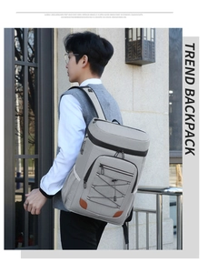 Detail view of grey thermal picnic backpack with elastic bungee cords and leather accents