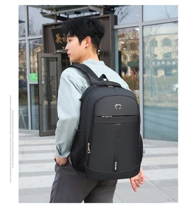Outdoor shot showing side view of black multifunctional backpack with side mesh pockets