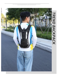 Outdoor cycling backpack with bungee cords shown on a hiker in a natural setting