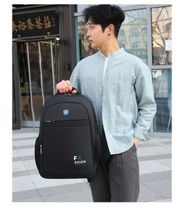 Detail view of the black Oxford cloth business backpack with a blue shield logo
