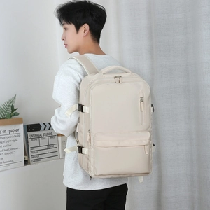Sac à dos de voyage beige minimaliste à grande capacité porté par un modèle en intérieur