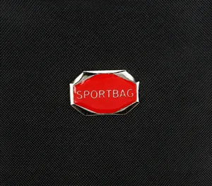 Detailed macro view of the black nylon fabric and the red octagonal metal Sportbag logo