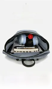 Spacious interior of dark grey ripstop backpack holding tablet, books and headphones