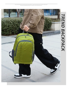 Outdoor green lightweight backpack shown during casual walking in a street scene