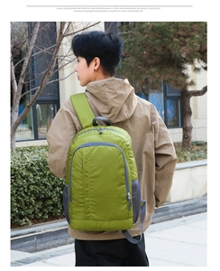 Outdoor green nylon backpack with grey mesh side pockets and front zipper detail