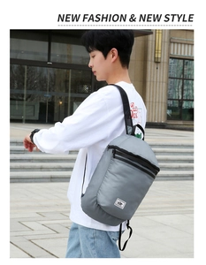 Gray foldable outdoor backpack with durable nylon fabric and large capacity shown on model