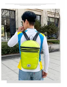 Detail of light green foldable backpack featuring water-resistant ripstop nylon material