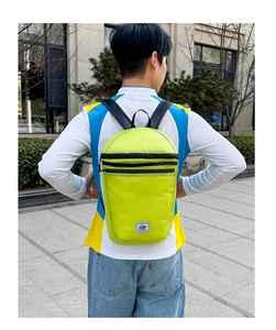 Close-up of lightweight neon green waterproof nylon outdoor backpack with brand logo