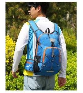 Detail of blue nylon outdoor backpack with reflective safety strips and storage pockets