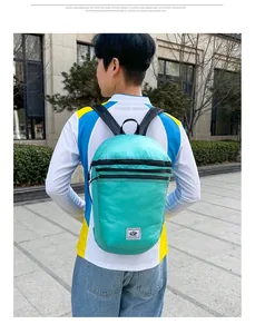 Rear view of a mint green lightweight foldable backpack for outdoor sports and travel