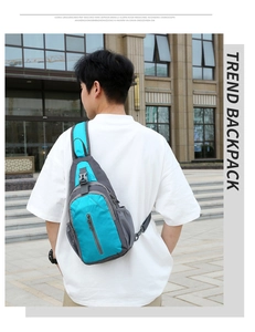 Outdoor waterproof nylon sling bag in blue and grey shown on model back for scale