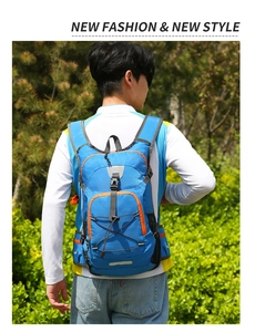 Detail view of blue outdoor backpack with orange trim and reflective safety strips