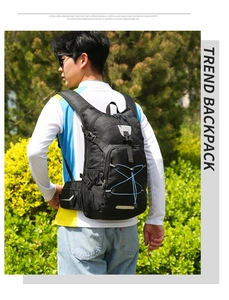 Detail of black nylon outdoor backpack with blue bungee cords and chest stability buckle