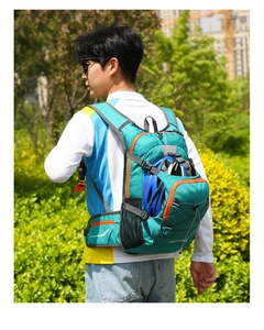 Detail view of teal nylon hiking backpack with orange trim and helmet storage net