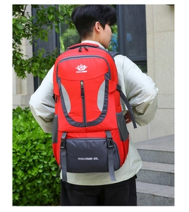 Outdoor view of 60L red and grey waterproof hiking backpack on model's back