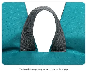 Close-up of the grey high-density webbing handle on the blue ripstop fabric travel backpack