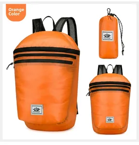 Macro detail of foldable orange ripstop nylon backpack showing storage pouch and logo
