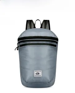 Front view of grey lightweight folding backpack with parallel zippers and mesh straps