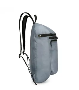 Side view of gray lightweight folding backpack in durable ripstop nylon fabric