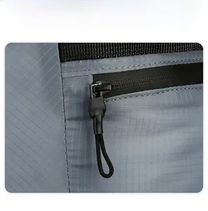 Detail of durable black zipper and tear-resistant nylon fabric on the gray folding backpack