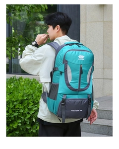Detailed back view of a 60L cyan hiking backpack with padded straps on a person