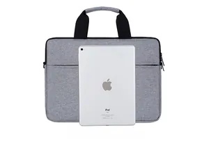 Gray laptop bag detail showing front zipper pocket and size comparison with tablet