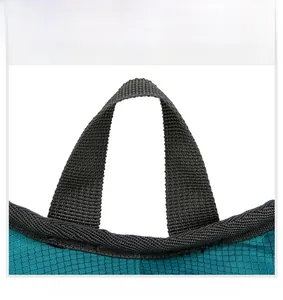 Close-up of high-density nylon top handle and diamond pattern fabric on blue backpack