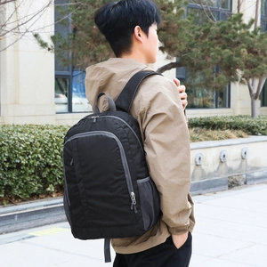 Classic black outdoor backpack with gray accents and mesh side pockets for travel