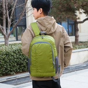 Grass green lightweight outdoor sport backpack shown on male model in city setting