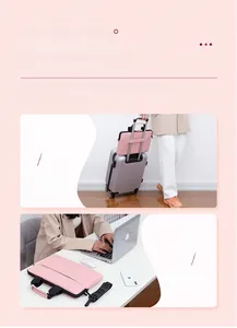Pink PU leather laptop bag detail showing detachable strap and luggage handle strap
