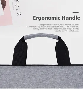Close-up of ergonomic padded handle on gray laptop bag with reinforced nylon stitching