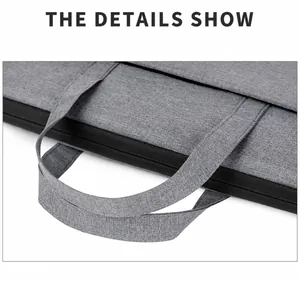 Detalle de asas acolchadas y cremallera de maletín gris impermeable para computadora