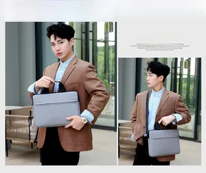 Grey fabric laptop bag with black top handles and adjustable shoulder strap for casual look