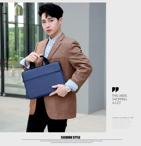 Business laptop bag in navy blue fabric with a hidden front pocket and sturdy black handles