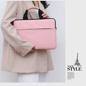 Pink laptop shoulder bag with black handles and front pocket held by model in suit