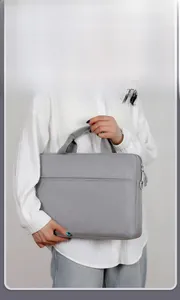 Detail showing slim light grey laptop bag with front pocket and durable fabric texture
