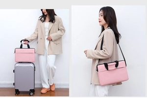 Pink waterproof laptop bag showing trolley strap and adjustable shoulder strap detail