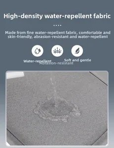 Close-up of high-density water-resistant fabric showing beads of water on gray laptop bag