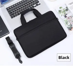 Detail of the black nylon laptop bag featuring reinforced handles and a padded strap