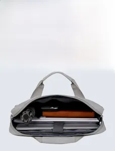 Internal view of a light gray laptop bag featuring organized compartments for tech accessories