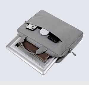 Detail showing laptop and tech accessories in gray fabric business briefcase compartments