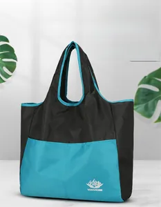 Detailed view of foldable nylon travel bag with Vanaheimr logo and two-tone design