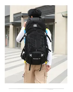 Detail of 60L black hiking backpack showing buckle straps and thick waist support system