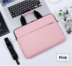Detailed top view of pink laptop bag with black handles and detachable shoulder strap